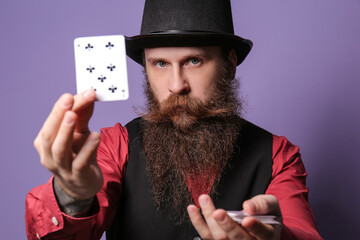 Wall Mural - Male magician with cards on color background