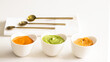 Three typical Canary Islands sauces, mojo picon, mojo verde  and almogrote  in ceramic bowl on modern restaurant table