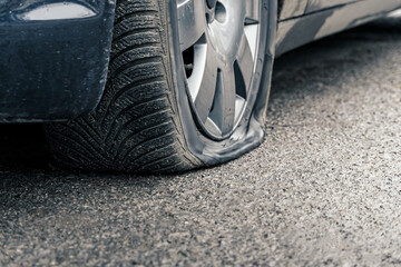 flat car tire close up, punctured wheel