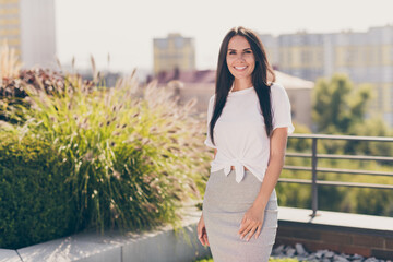 Poster - Photo portrait of pretty young brunette girl smiling cheerfully wearing stylish outfit relaxing outdoors in summer