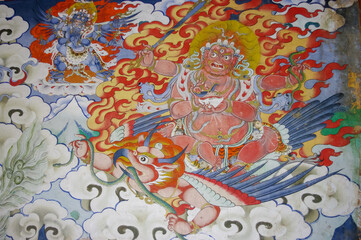  Colorful traditional wall painting of wrathful deity riding garuda in Gangtey gompa or monastery, Phobjikha valley, Bhutan