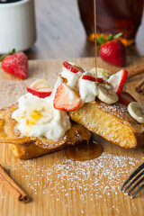 Wall Mural - French Toast. Bread dipped in eggs milk and sugar then fried in cast iron skillet with butter topped with fresh fruit powdered sugar and maple syrup. Brunch or breakfast favorite. 