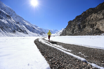 Woman trail runner cross country running in winter nature