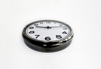 Analog clock with the hands hanging on a white wall seen from below. Time concept.