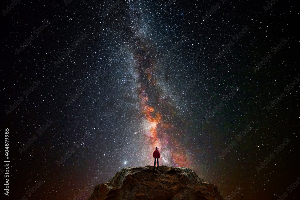 Man on top of a mountain observing the universe - obrazy, fototapety, plakaty 