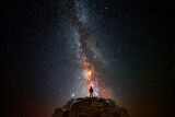 Fototapeta Kosmos - Man on top of a mountain observing the universe