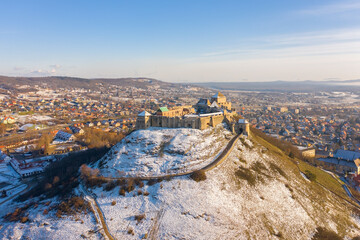 Wall Mural - Sümeg, Veszprém county, Hungary - Snowy aerial view of the Castle of Sümeg, 20 miles north of Lake Balaton. Castle Hill covered by snow. Built in the mid or late 13th century by Béla IV of Hungary.