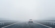 © Igor Link - a car on the freeway in the heavy fog