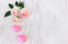 Flowers Pink Roses With Pink Hearts On Background Of White Painted Wooden Table With Space For Text. Decoration Of Valentine Day
