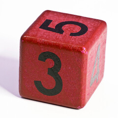 Number three and five written on a red wooden cube of a calendar date