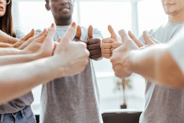 Wall Mural - close up. group of young people showing thumbs up.