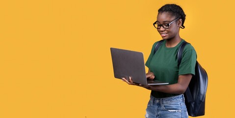 Aufkleber - Cheerful Black Student Woman Using Laptop Over Yellow Background, Panorama