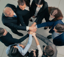 Wall Mural - top view. boss and business team making a stack of hands