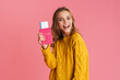 © Drobot Dean - Happy beautiful blonde girl smiling while holding passport with tickets