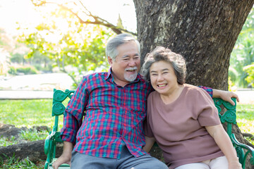 Wall Mural - Portrait senior couple. Old man and old woman love each other Elderly man and elderly woman get happiness with smile face at park. Old wife and husband have good health, health care insurance concept