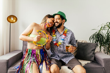 Brazilian Carnival. Couple celebrating carnival at home