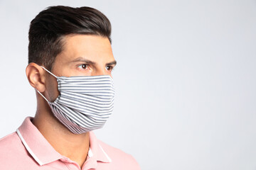 Canvas Print - Man in protective face mask on white background