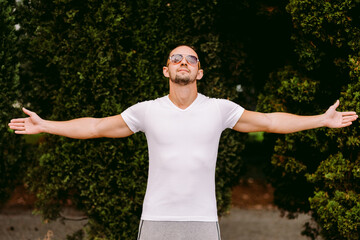 Man in blank white t-shirt v collar, front view outdoors. Design men t shirt template and mock-up for print 