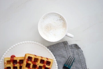 Wall Mural - Breakfast with Belgian waffles and coffee and milk foam