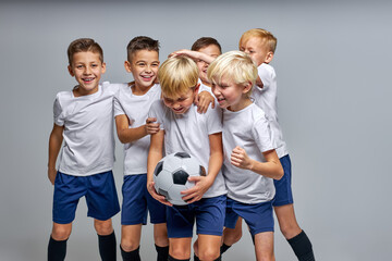 children soccer players have fun celebrating, smiling, enjoying sport games. football match, sport concept