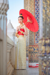 Wall Mural - Luxury portrait of a beautiful Thai girl in traditional thai red costume, identity culture of Thailand, identity culture of Asia