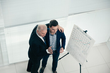 Wall Mural - top view. project Manager and employee standing near the flipchart