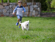 Boy Running and Playing with Dog
