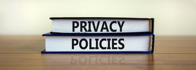 Wall Mural - Privacy policies symbol. Concept words 'Privacy policies' on books on a wooden table. Beautiful white background. Business and privacy policies concept, copy space.