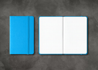 Poster - Blue closed and open lined notebooks on dark concrete background