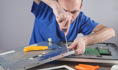 Wall Mural - Electrician engineer repairing computer monitor.