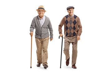 Sticker - Full length portrait of two elderly men with canes walking towards camera