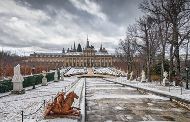 Snowy public gardens, historic fountains and exterior of the Baroque Palace of La Granja de San Ildefonso, Segovia, Castilla y Leon, Spain