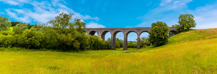 Wall Mural - A panorama view along the valley floor of the northern side of the derelict and abandoned viaduct near Catesby, Northamptonshire, UK