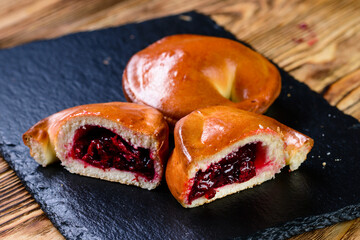 Canvas Print - Traditional Russian baked pies pirozhki patties. russian homemade pies with berries