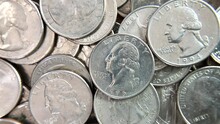 4K HD Video Zooming In On One Coin In The Middle Of A Pile Of Quarters. The Quarter Dollar Made In 1804 Was The First Silver Coin In The United States Mint's History To Have A Value Printed On It.

