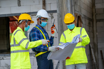 Aufkleber - Engineer wearing protective mask to Protect Against Covid-19 and checking production process at the construction site,Engineer,Construction concept,Coronavirus has turned into a global emergency.