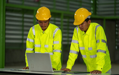 Aufkleber - Engineer working at factory,Engineers in hard hats discuss new project while using laptop.