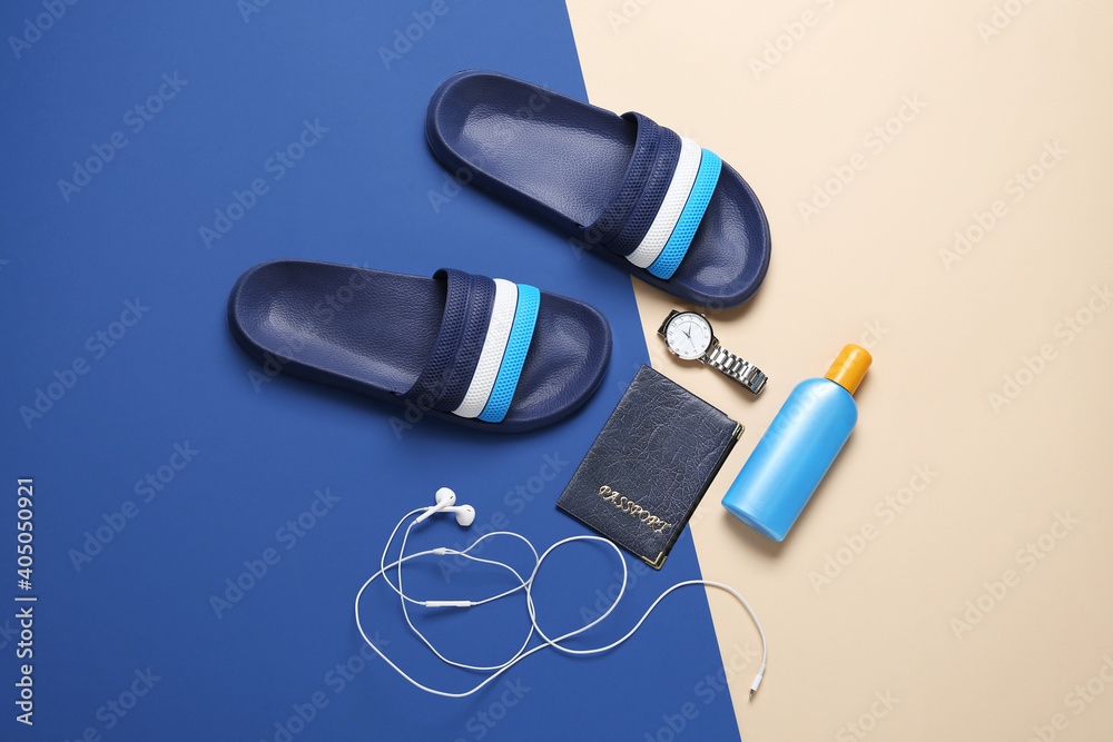 Set of male beach accessories on color background