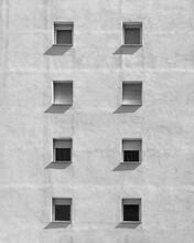 Grayscale Photo Of Windows On White Facade Of A Building