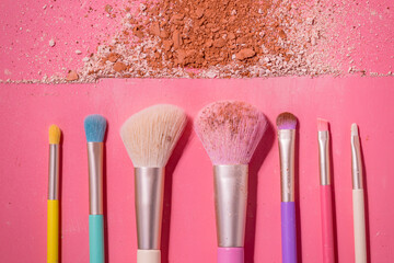 Canvas Print - Make up brushes with powder on pink background