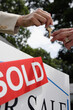 © SuperStock - Real estate agent handing house keys to buyer