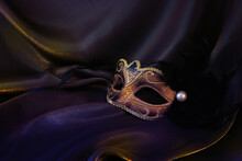 Photo Of Elegant And Delicate Gold Venetian Mask Over Dark Silk Background
