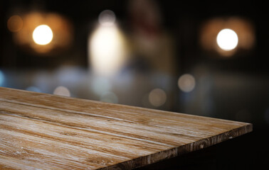 Empty wooden table in front of abstract blurred background of coffee shop . can be used for display or montage your products.Mock up for display of product