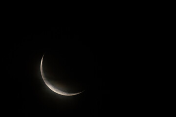 New moon on dark sky