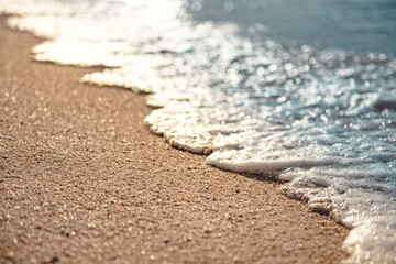 Close-up soft wave of the sea on the sandy beach