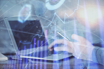 Poster - Double exposure of man's hands holding and using a digital device and forex graph drawing. Financial market concept.