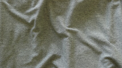 Wall Mural - crumpled gray cotton fabric with smooth folds on the surface, ash-colored drapery with casual lines of fabric bends, light plain backing of wavy material, empty texture background of the canvas