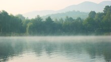 Foggy Lake In The Early Morning. Misty Mountain Lake At Sunrise. Picturesque Morning Scene.