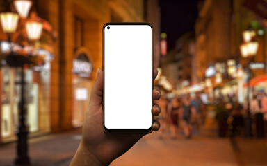Aufkleber - Phone mockup in woman hand at night. City street with lights in background