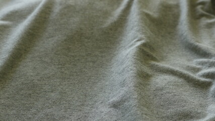 Wall Mural - close-up gray textured cotton fabric with slightly wrinkled folds, solid horizontal drapery with volumetric relief of bends, solid color full frame backdrop
